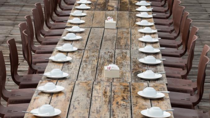 Long wooden dining table with place settings
