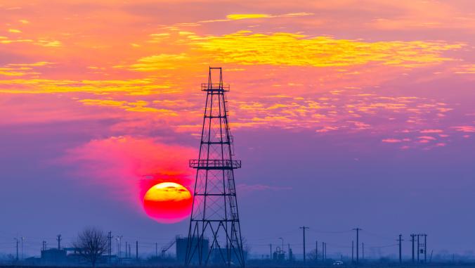 Oil and gas rig, with evening sky and sunset in background