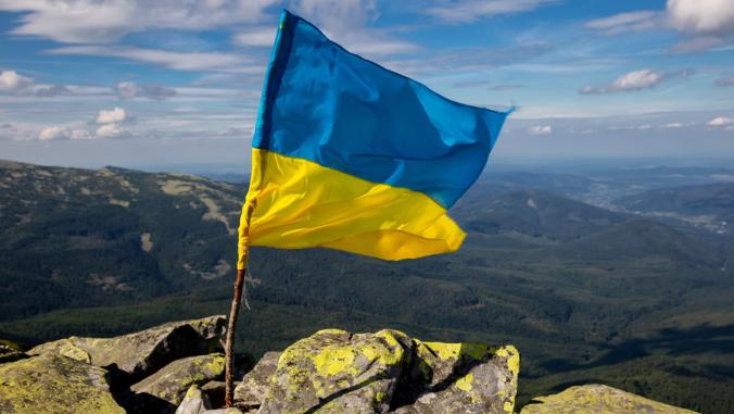 The flag of Ukraine above the Carpathian mountains.